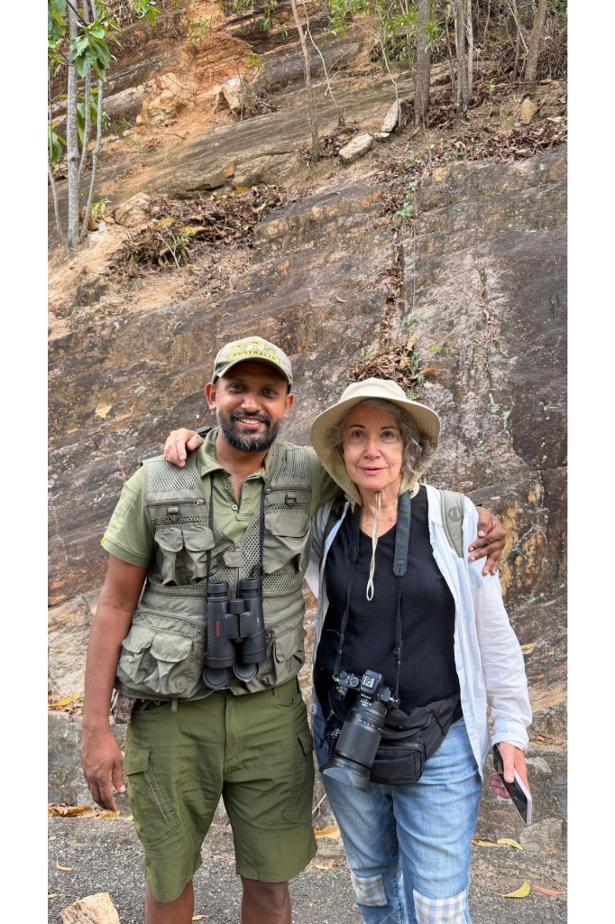 Guide Ravi in safari gear with binoculars alongside a guest photographer with camera on a personalized Knuckles trekking tour