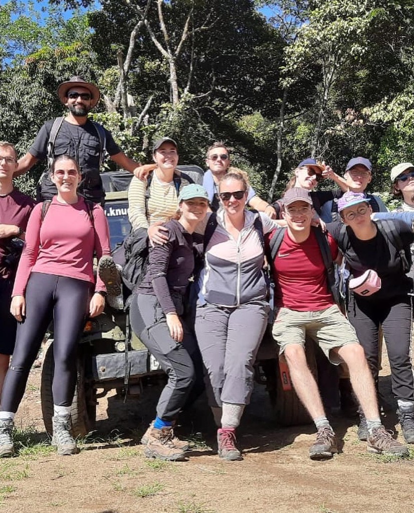 Group of adventure travelers and guide Ravi with an expedition 4x4 safari jeep in Knuckles